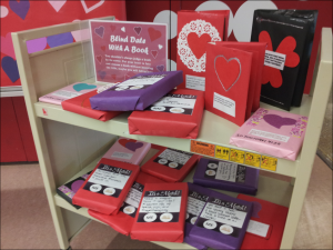 Cart with books wrapped for Blind Date with a Book display