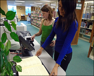 Two students scanning documents in the Library