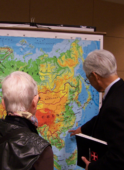 Members of the public look at a map