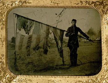 Union soldier with tattered US flag