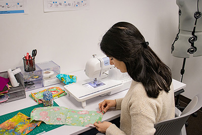 Student working with sewing machine