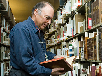 Tony Gardner browsing books in Special Collections
