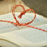 Open book with heart-shaped string across it