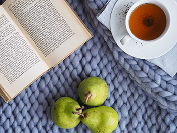 a book, pears and a cup of tea