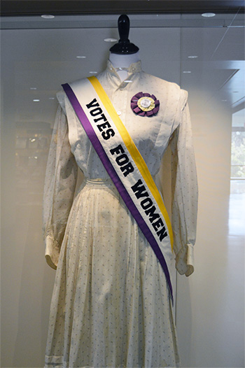 woman's dress with sash reading: votes for women