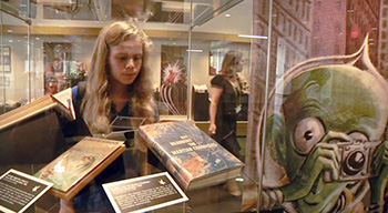 A Young Student Looking at an Exhibition in the Library Gallery