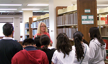 Librarian Coleen Martin giving a tour to outreach students.