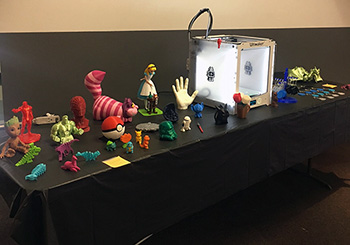 Table with 3D printer and 3D printed objects