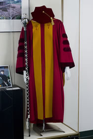 CAP AND GOWN WITH MACE BELONGING TO LIBRARY DEAN SUSAN CURZON