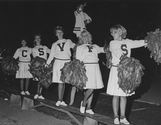 CHEERLEADERS RALLY CROWD ENTHUSIASM DURING A GAME, 1960s
