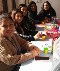 Five CSUN students smiling at Arts & Crafts table