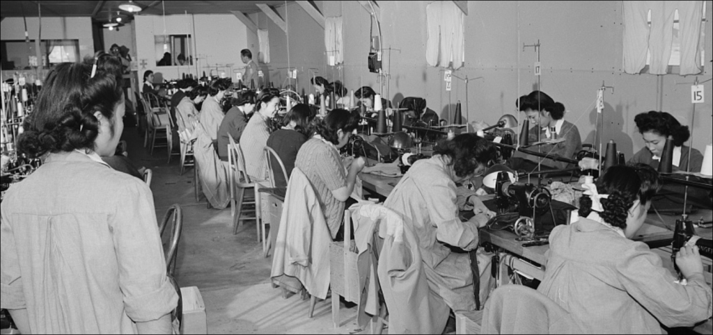 girls working at sewing machines in factory