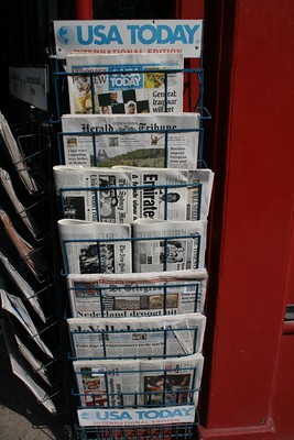 news stand display of newspapers