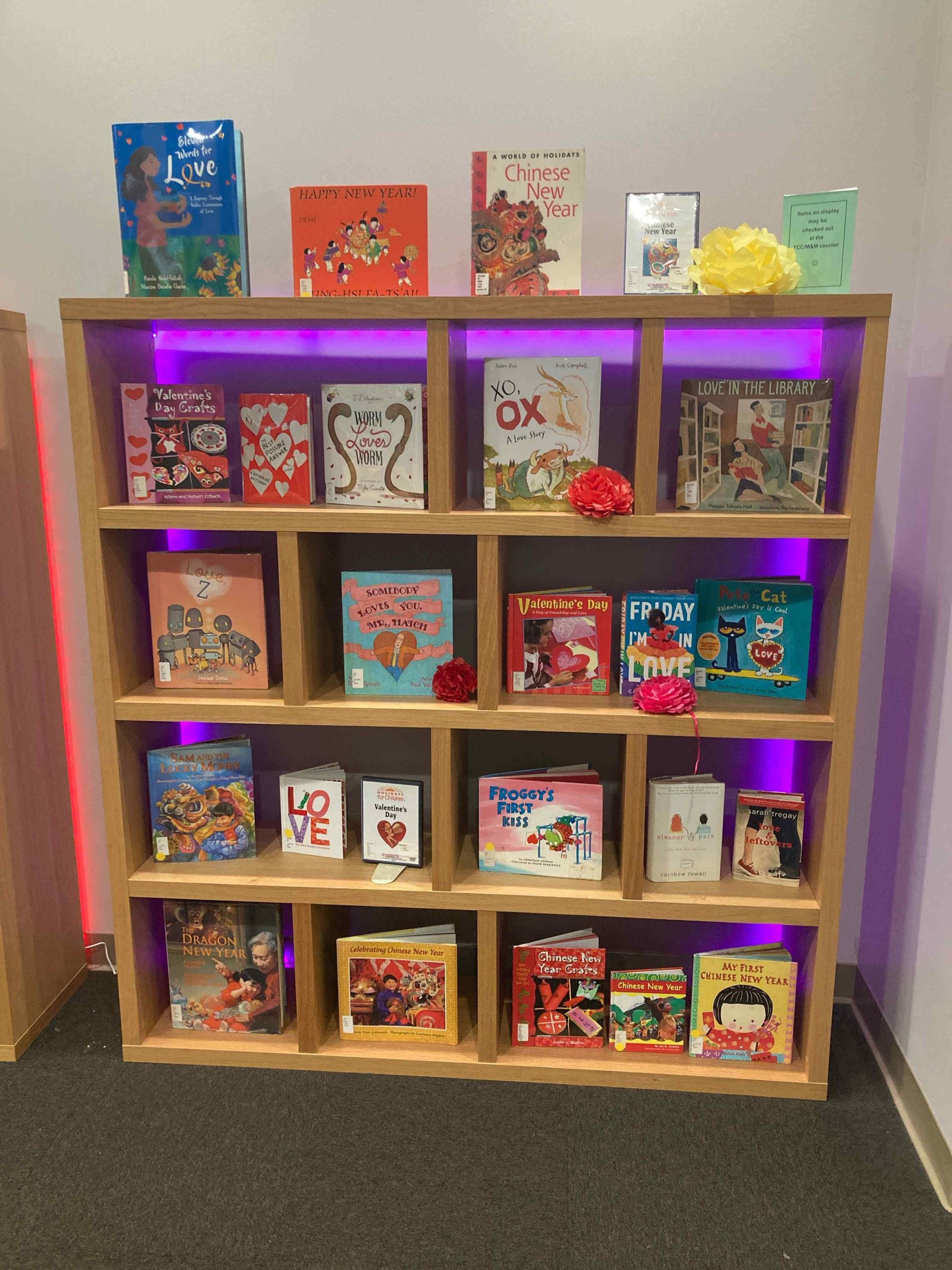 Photo of a book display shelf with several childrens' books about Chinese and Lunar New Year