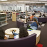 Librarians at the new reference desk, and students enjoying our new furniture.