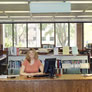 Librarian seated at the old reference desk.