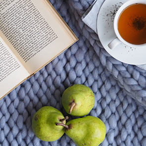 a book, pears and a cup of tea