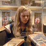 Young woman looking at exhibit.