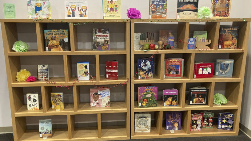 Bookshelf in the Teacher Curriculum Center with books, toys, and various learning materials.
