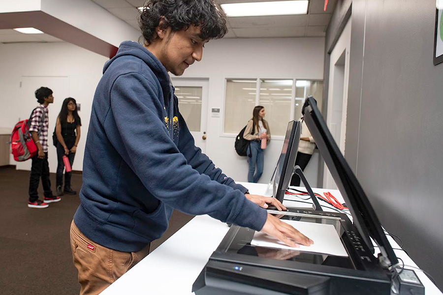 Student using a flatbed scanner