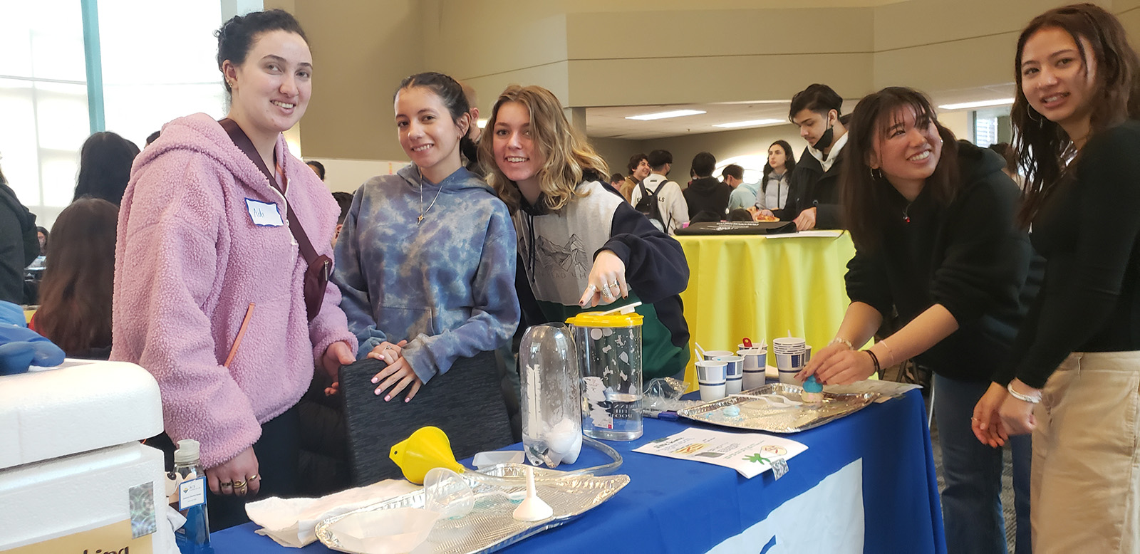 students at an event table