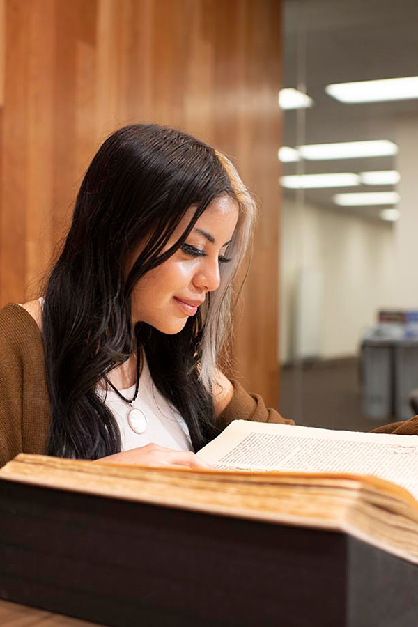 Student reading a book in the CSUN University Library's Special Collections & Archives