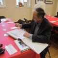 Tony Jorge da Silva inscribes a copy of his book to the Archives