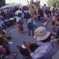 Children and adults dancing in a drum circle near Leimert Park, affectionately called Africatown, 1998. Roland Charles Collection, Box 75.