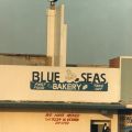 Exterior view of the Blue Seas Bakery, a chain of bakeries throughout the US run by the Nation of Islam. The Nation of Islam, a religious and black nationalist organization, had a strong presence in South LA. The community is well-known for funding its operations by running bakeries that distinctively offer bean pies because their former prophet, Elijah Muhammad, promoted eating navy beans. Circa 1980-1989. Roland Charles Collection, Box 78. 