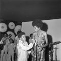 A young Michael Jackson (foreground, left), speaks into a microphone next to Diana Ross at the Daisy Club in Beverly Hills while the rest of the Jackson 5, including (background L-R) Tito Jackson, Marlon Jackson, Jackie Jackson, and Jermaine Jackson, look on. Guy Crowder Collection