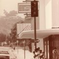 Residents wait for the traffic light as cars pass by on a Crenshaw corner, circa 1980-1989. Roland Charles Collection, Box 82. 