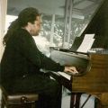 Photograph, Nate Morgan playing piano at a Double M Jazz Salon, 1996