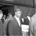Malcolm X and pallbearers escort the body of Ronald Stokes from the funeral service, Harry Adams Photograph Collection