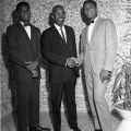 Boxing heavyweight champion Cassius Clay (right) and his brother boxer Rahman Ali (at birth known as Rudolph Valentino Clay) pose with California Assembly candidate for the 55th district, Rev. F. Douglas Ferrell, 1962. Harry Adams Collection. ID: 93.01.HA.B6.N45.965
