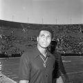 Heavyweight boxing champion and activist Muhammad Ali attends the Freedom Football Classic at Los Angeles Memorial Coliseum. Civil rights activist Willis Edwards is standing behind Ali, 1973. Harry Adams Collection. ID: 93.01.HA.N120.B25.11.51.02