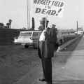 Leon Washington, publisher of the Los Angeles Sentinel, holds a	sign stating “Wrigley field is dead!” while protesting the decision to tear down Wrigley Field. 1964, Harry Adams Collection, 93.01.HA.B6.N45.1127