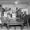 Rev. Maurice Dawkins and other ministers display protest signs. The ministers protest in support of Dr. King in Birmingham, Alabama for aid in the integration fight and against the atrocities being committed against integration fighters. In May, the Freedom Rally was held at Wrigley Field to raise funds to send to Birmingham and to aid Dr. King and the SCLC, in part, for bail for the thousands jailed. 1963, Harry Adams, 09.01.HA.N45.B17.199