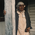 Portrait of Aunt Lulee (Beatrice White Bolden), daughter of Robert Celestin, stands on her porch. TBC.RCH