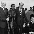 Senator Allan Cranston, Congresswoman Yvonne Brathwaite Burke, County Supervisor Kenneth Hahn, and an unidentified woman pose for a group portrait at an outdoor event. 1973. Digital ID: 91.01.GC.P.B1.24