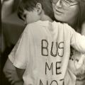 A mother holds her son at a BUSTOP campaign rally, ca.1980