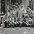 Maj. James C. Magee (front row center) poses with his battalion staff at British Embassy compound billet, Peking 1945