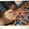 Tattoo artist at work, in 1000 Tattoos, 1996