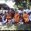 A group of people smile pose for a picture. Deeptha can be seen in the bottom right, 1980