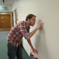 Mounting the exhibition.  Student assistant Tim Kaufler finds the exact spot