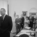 President Lyndon Johnson with the press at a news conference in the Oval Office. Helen Thomas at the rear with a pad and pen