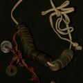 A collection of Chinese coins on a thin rope or shoelace collected by Lawson during WWII