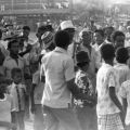 Men and boys gather before bullfight, 1975