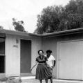 Mrs. Storey and a friend in front of their first home in Pacoima, December 1958