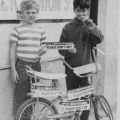 Two young boys pose with bicycle adorned with Herald strike bumper stickers