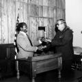 Raymond Carter receives a gavel as the new Toastmasters president, 1977